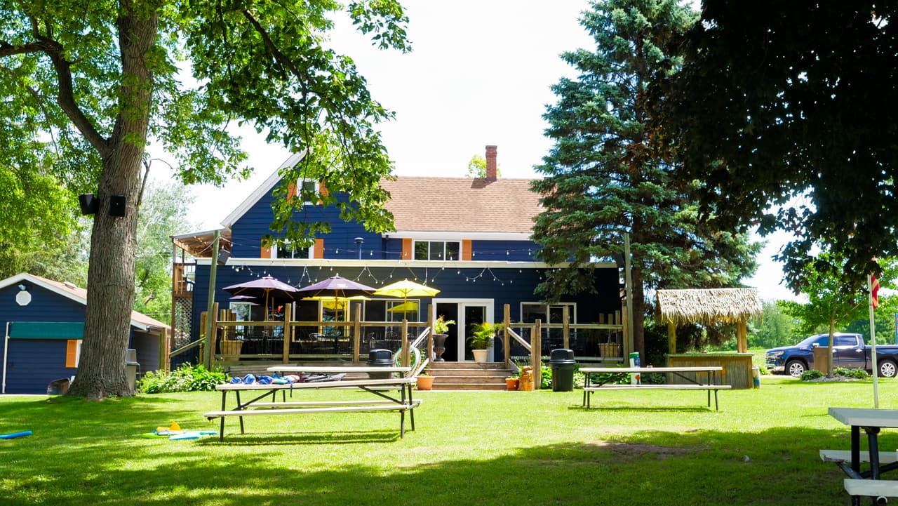 Big lawn with picnic tables in front of the main building